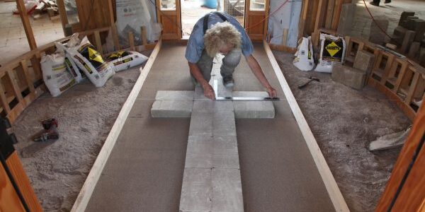 Henry Wiersma installs the Compressed EarthBlock Floor